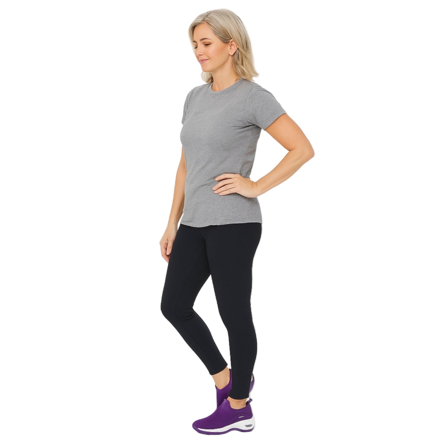 Woman wearing a gray t-shirt, black leggings, and purple shoes on a white background